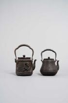 TWO JAPANESE CAST-IRON TETSUBIN AND COVERS MEIJI ERA, 19TH/20TH CENTURY One decorated with a vase of