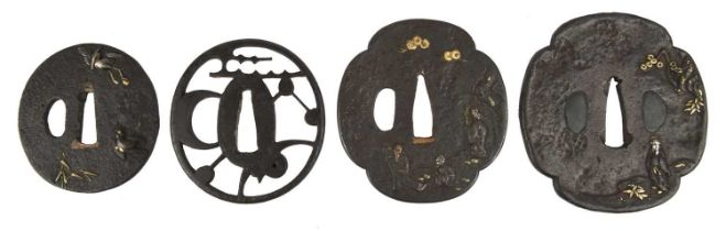Four Japanese sword guards (tsuba), iron, the first maru-gata, with a crane and a hawk in takka