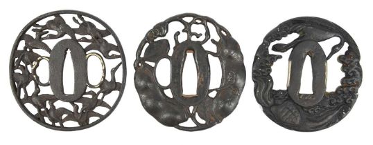 Three Japanese iron sword guards (tsuba), maru-gata, openwork and relief decorations, the first