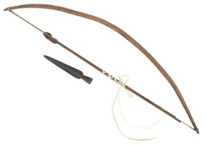 A small Congolese bow complete with two iron headed arrows, together with an iron pike head.