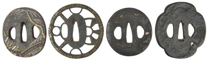 Four Japanese sword guards (tsuba), iron with inlaid decoration, the first maru-gata, with trees and