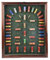 A glazed sporting cartridge display board, exhibiting a collection of 53 shot cartridges in the .