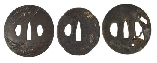 Three Japanese iron sword guards (tsuba), unsigned, the first maru-gata, relief and taka-zogan, a