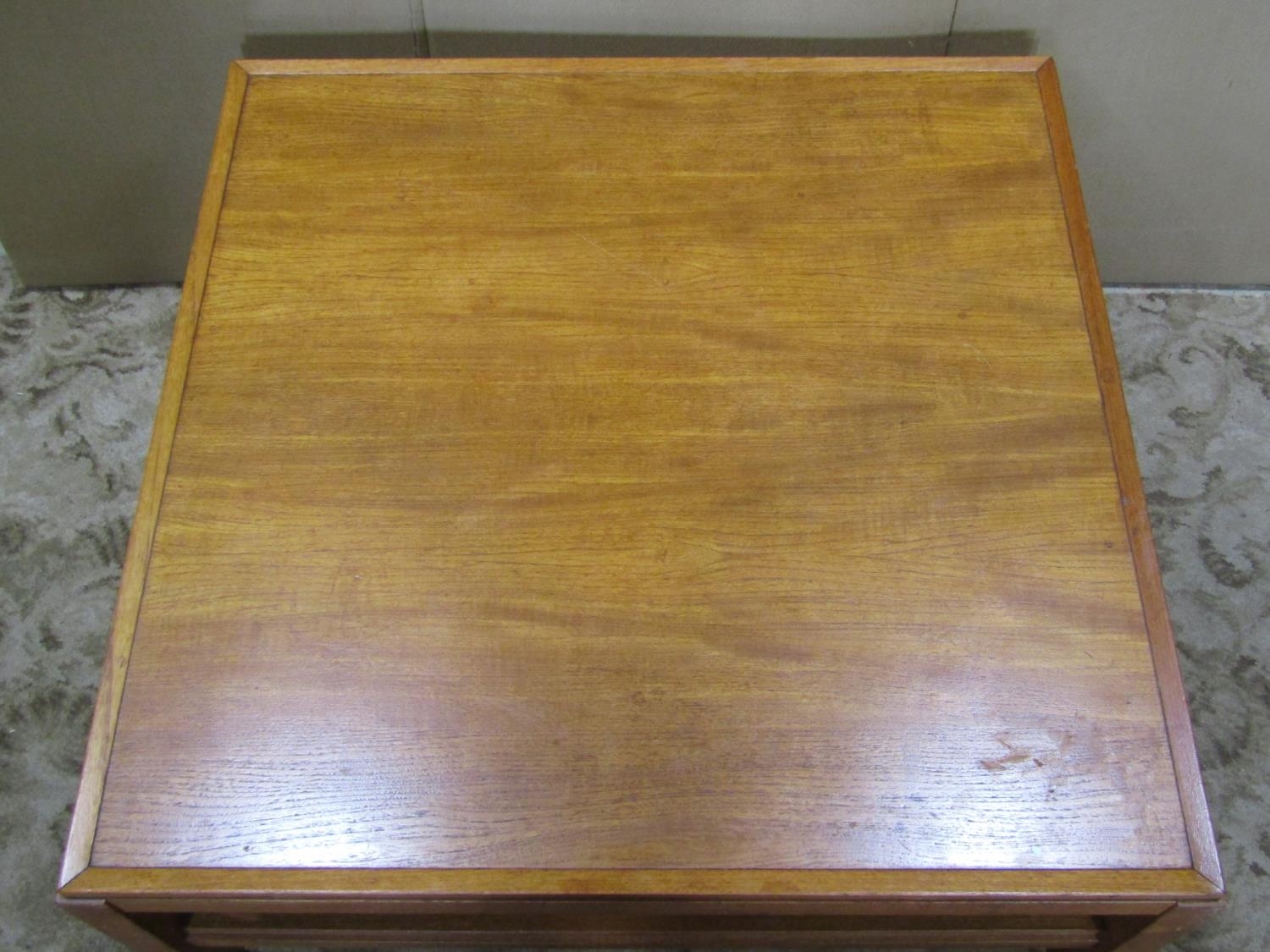 A low teak occasional table raised on square cut supports united by moulded stretchers, - Image 2 of 2