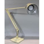 A Herbert Terry anglepoise lamp on a square two tier base in cream