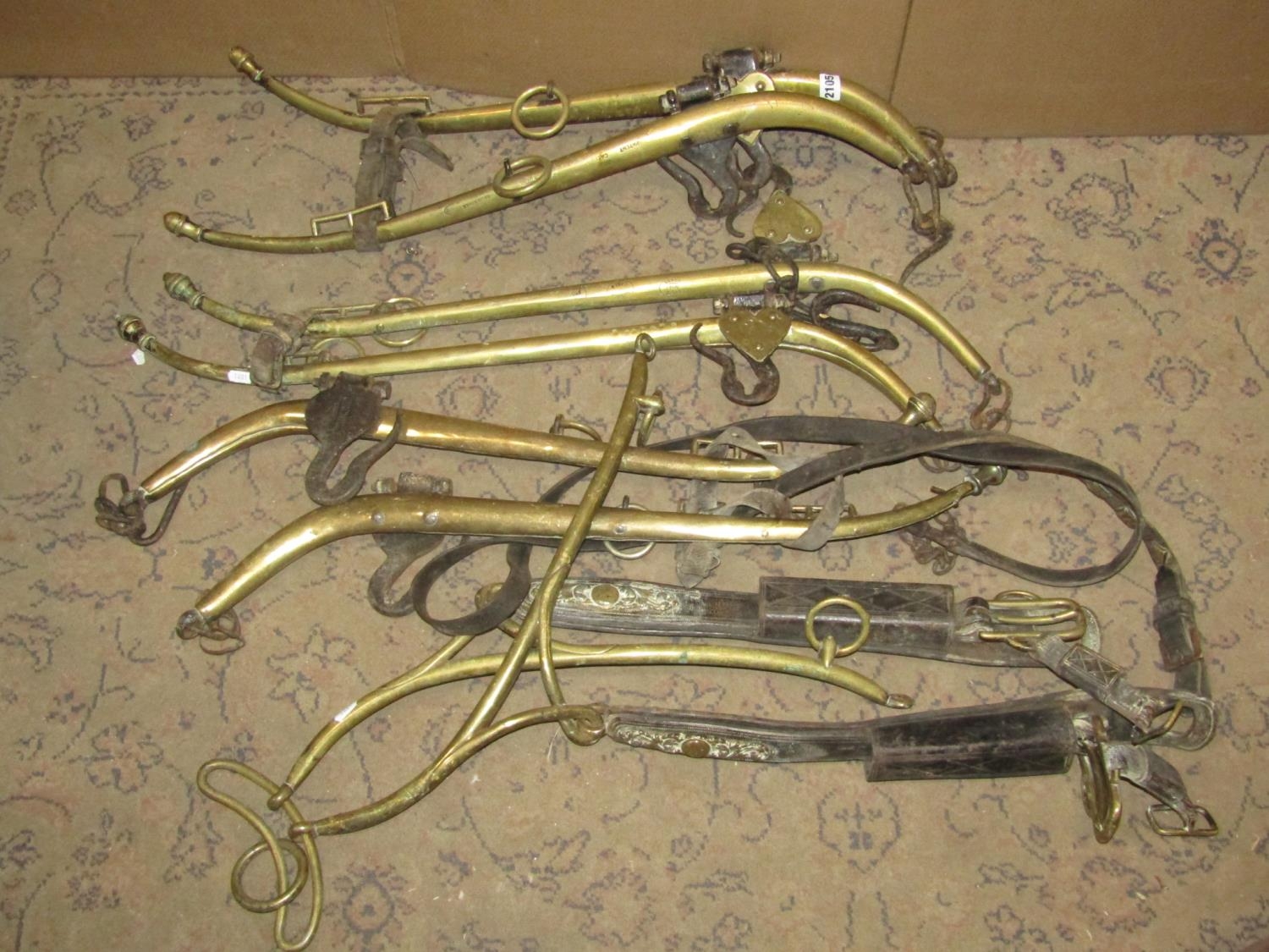 Four pairs of vintage brass hames with leather straps and iron fittings