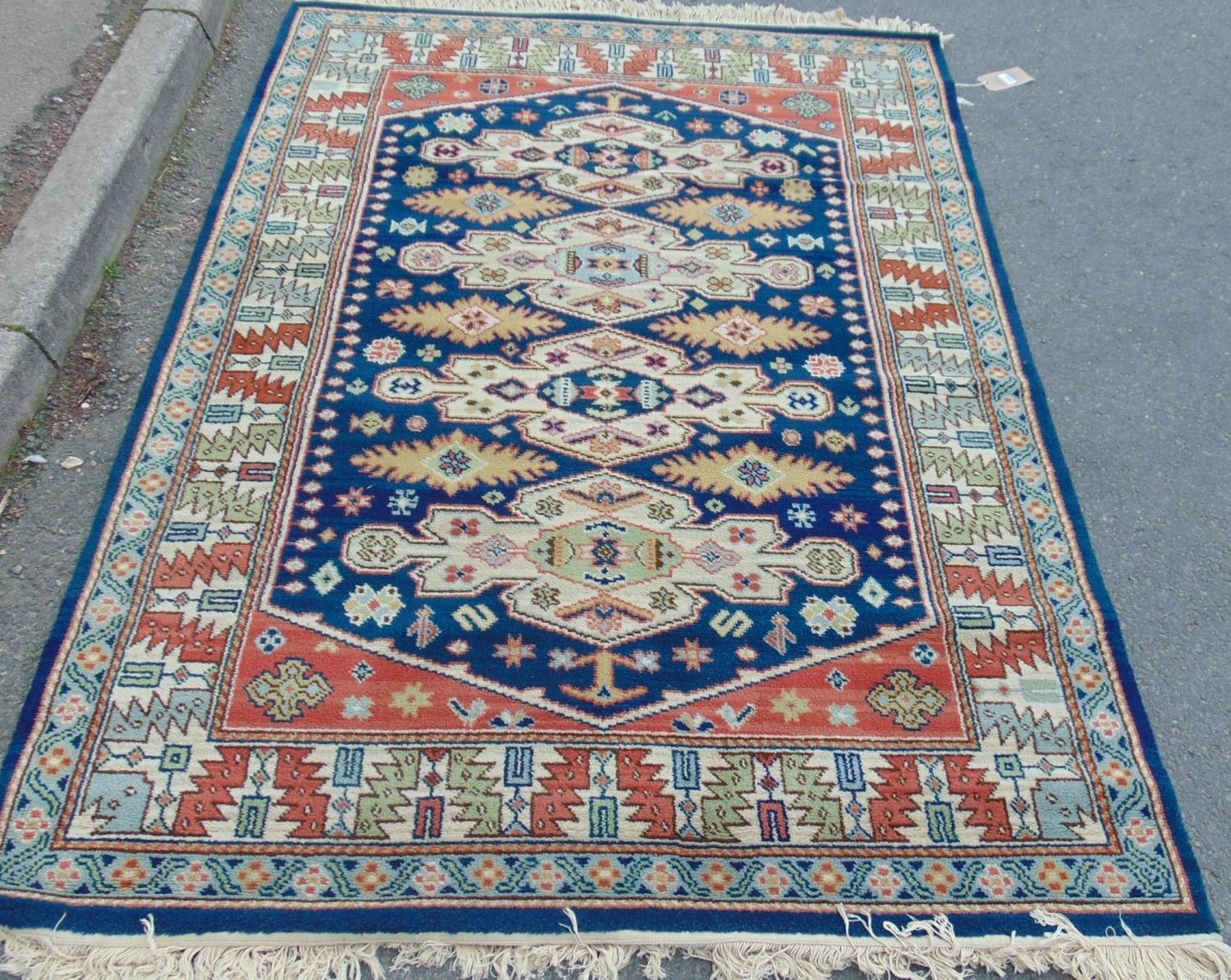 A Kazak design rug with four stepped medallions and geometric borders, 200 mx 140 cm approximately