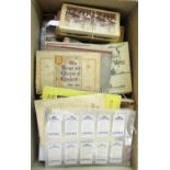 A box containing an unsorted collection of cigarette cards, some mounted, some unmounted, postcards,