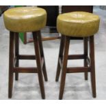 Two similar high stools with circular button leather seats raised on square cut tapered and