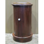An unusual Victorian mahogany cylindrical pot cupboard, the hinged inset marble top enclosing a