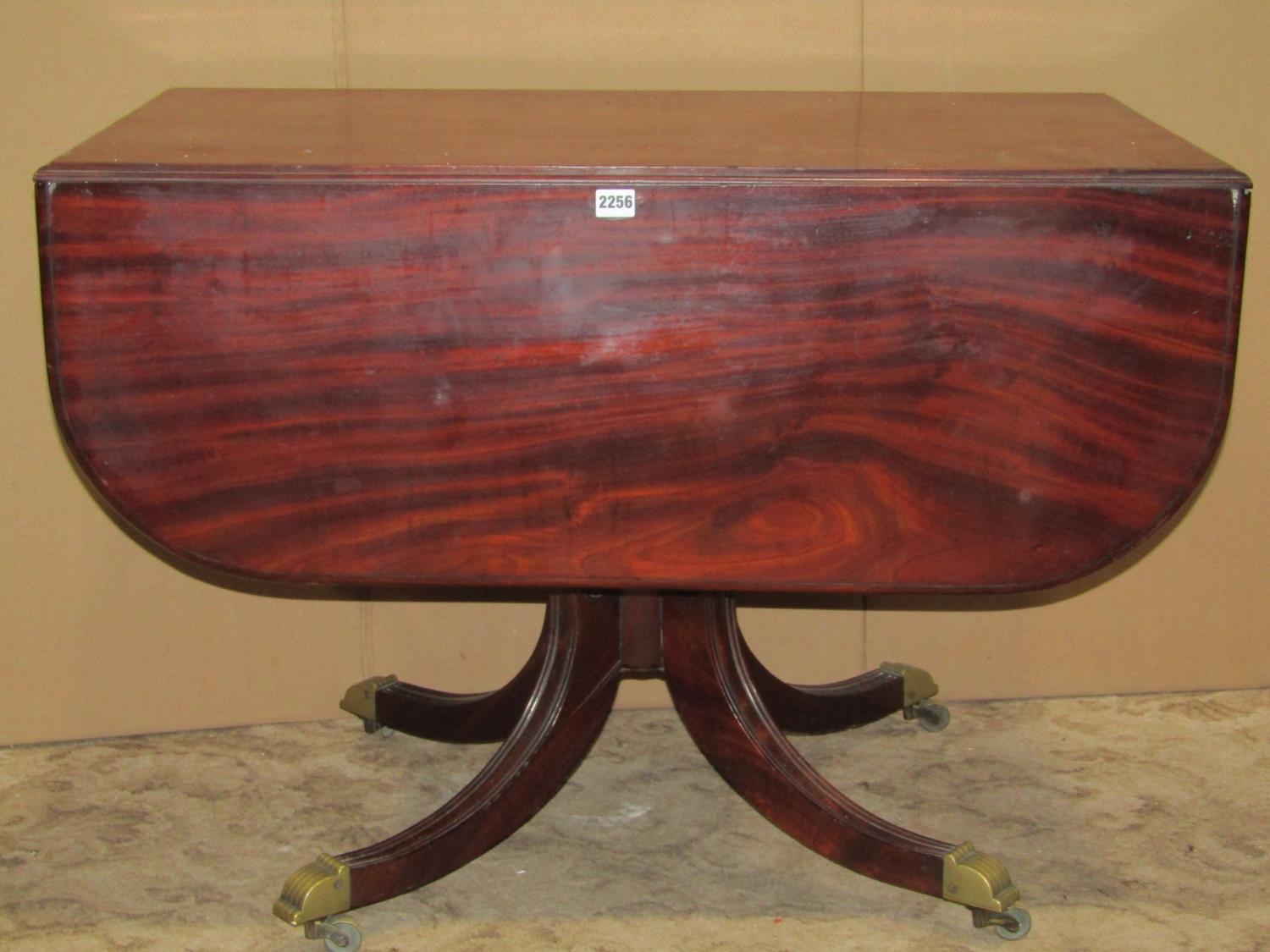 A 19th century mahogany drop leaf Pembroke breakfast table raised on a central turned pillar, 98