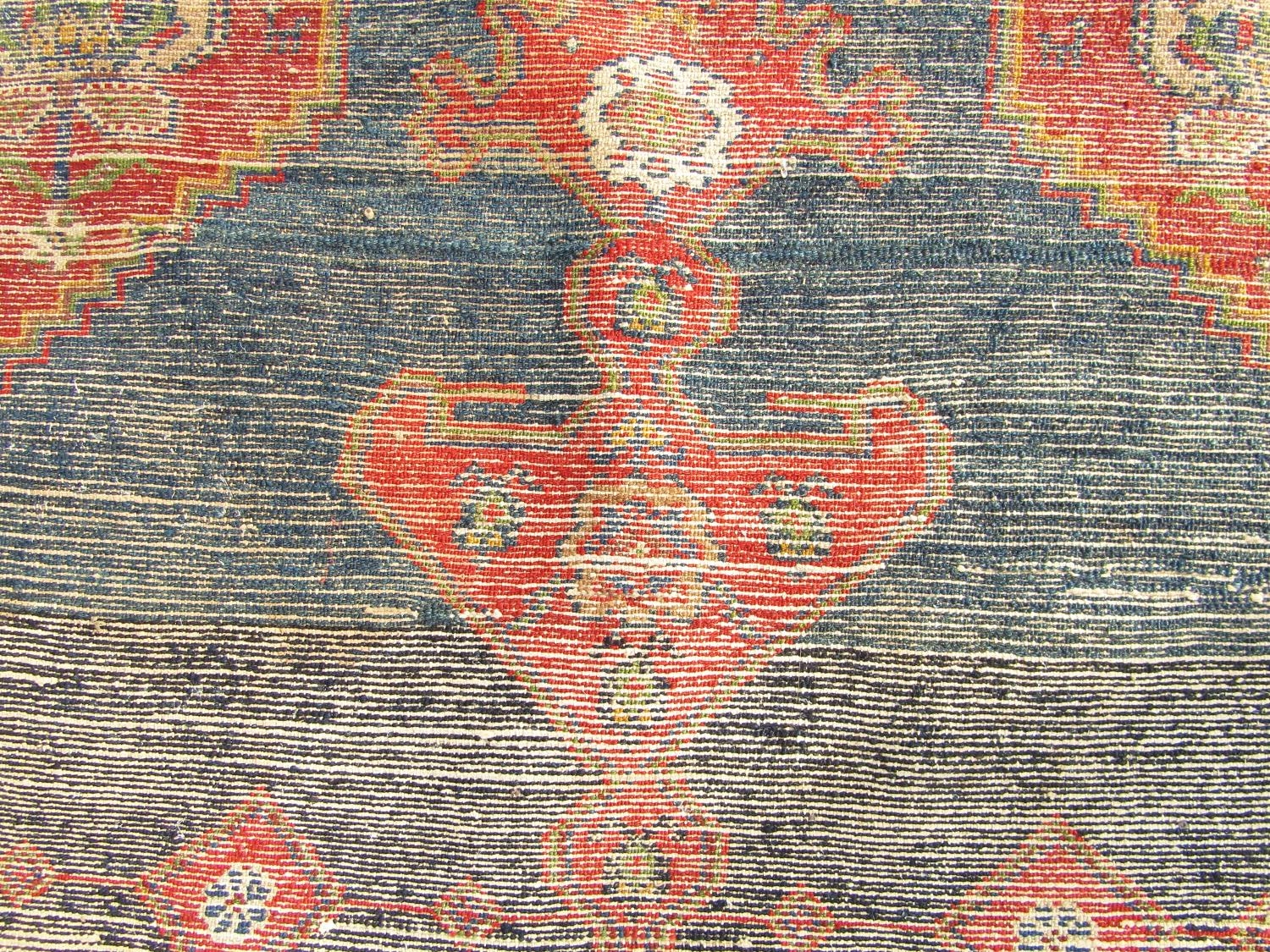 An old Kazak carpet with a central extended medallion and stylised flowers on a dark blue ground, - Image 4 of 4