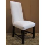 A set of eight simply upholstered high back dining chairs raised on square cut and moulded