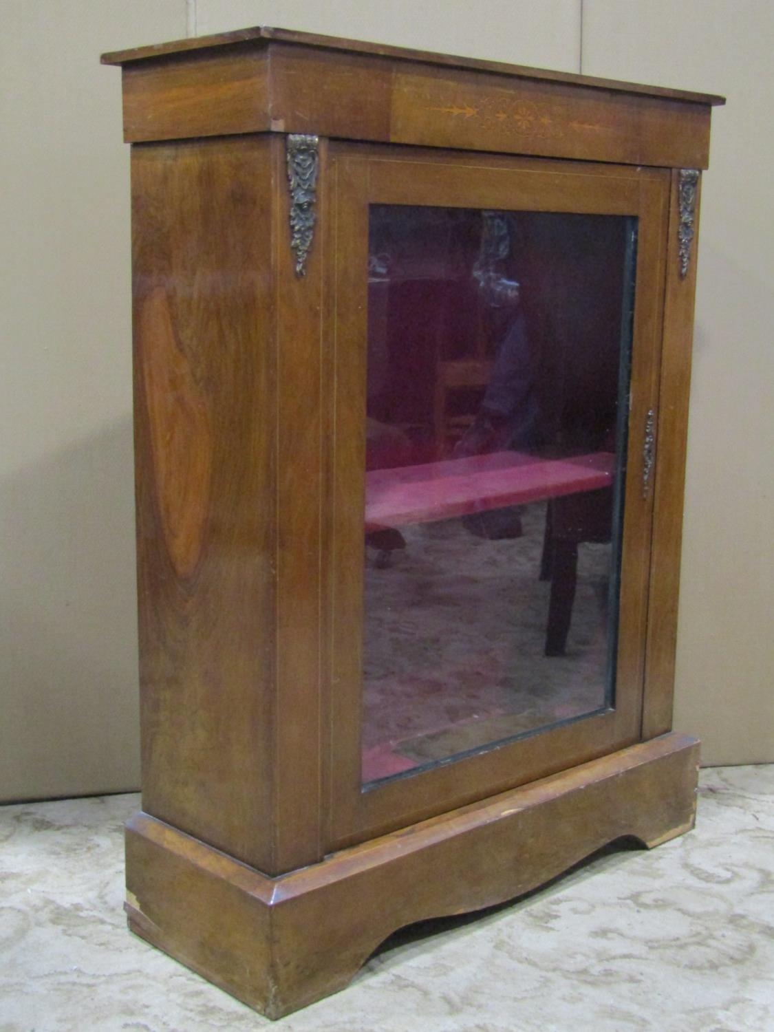 A Victorian walnut veneered pier cabinet with inlaid detail and enclosed by a single rectangular