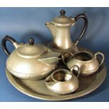 A four piece Craftsman Arts and Crafts style pewter hammered tea service with a similar Knighthood