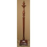 A mahogany standard lamp with partially turned and hexagonal tapered stem raised on a swept and