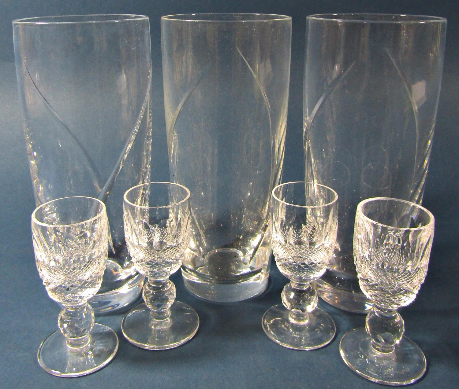 A miscellaneous collection of glass ware including a Smokey brown pitcher and six square shot