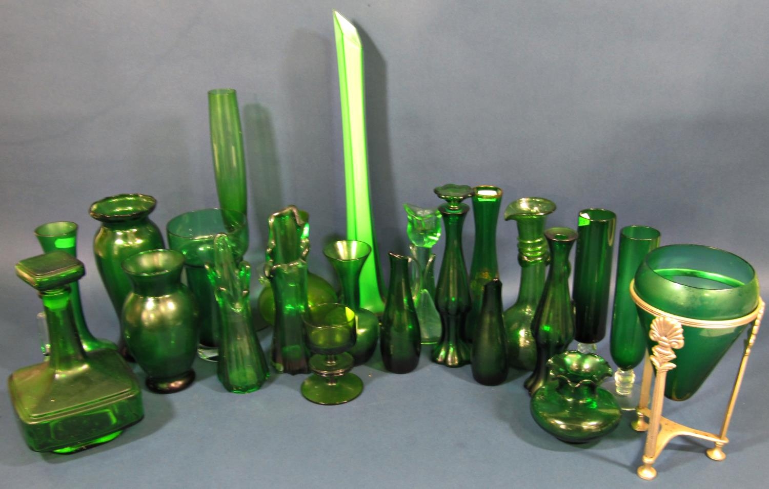 A collection of twenty three pieces of green glass mainly vases of varying shapes and sizes etc.