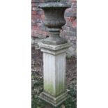 A small weathered marble urn, 25 cm diameter x 30 cm high raised on an associated weathered