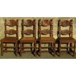 A set of four Victorian oak dining chairs with carved and turned frames and cane panelled seats