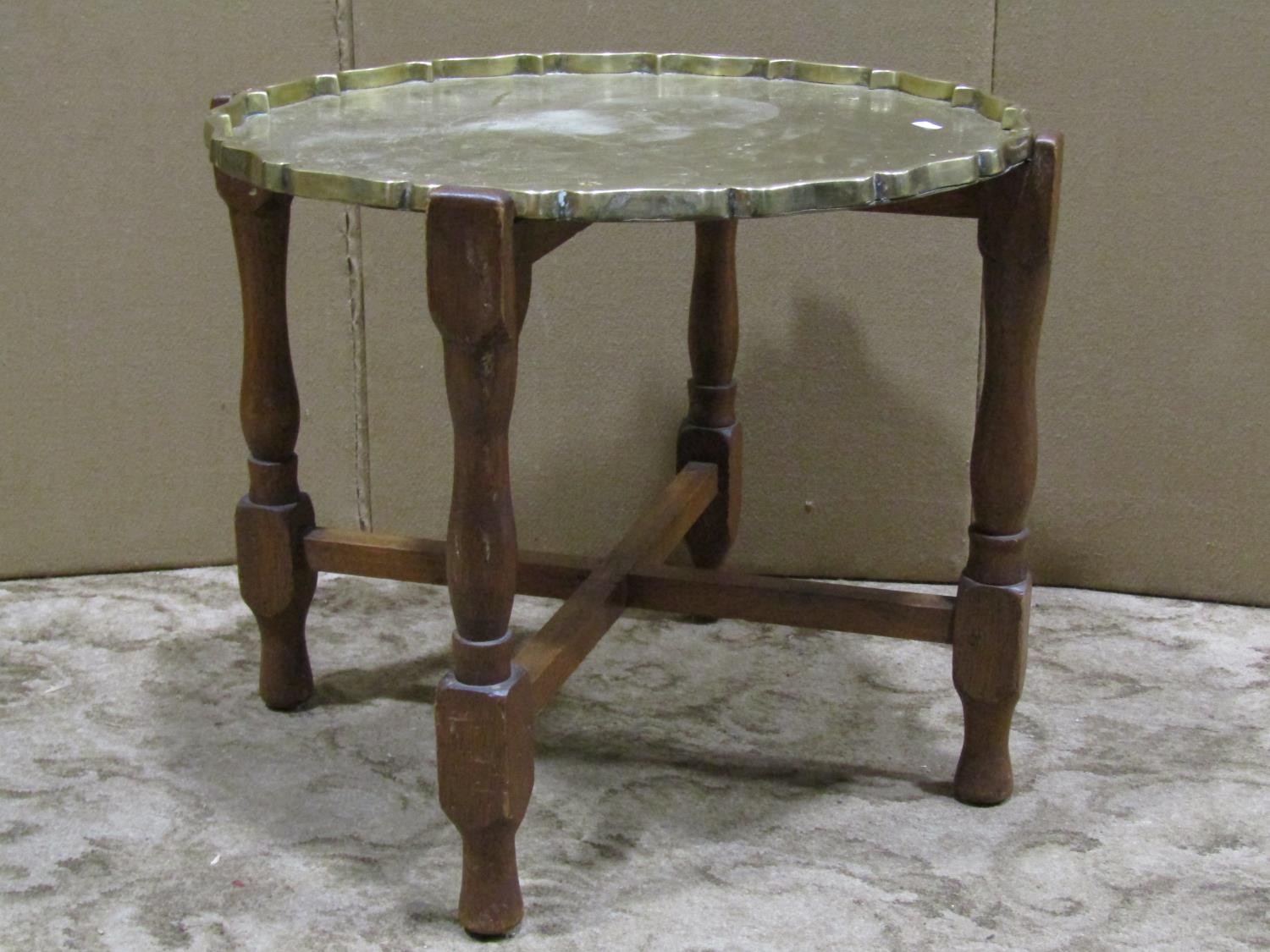 A heavy gauge Eastern brass/bronze polished circular tray top occasional table with shaped
