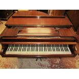 A Baby Grand Piano retailed by Duck Son & Pinker in a polished mahogany cased raised on three square