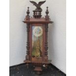 A 19th century walnut wall clock with shaped moulded supports enclosing an eight day striking