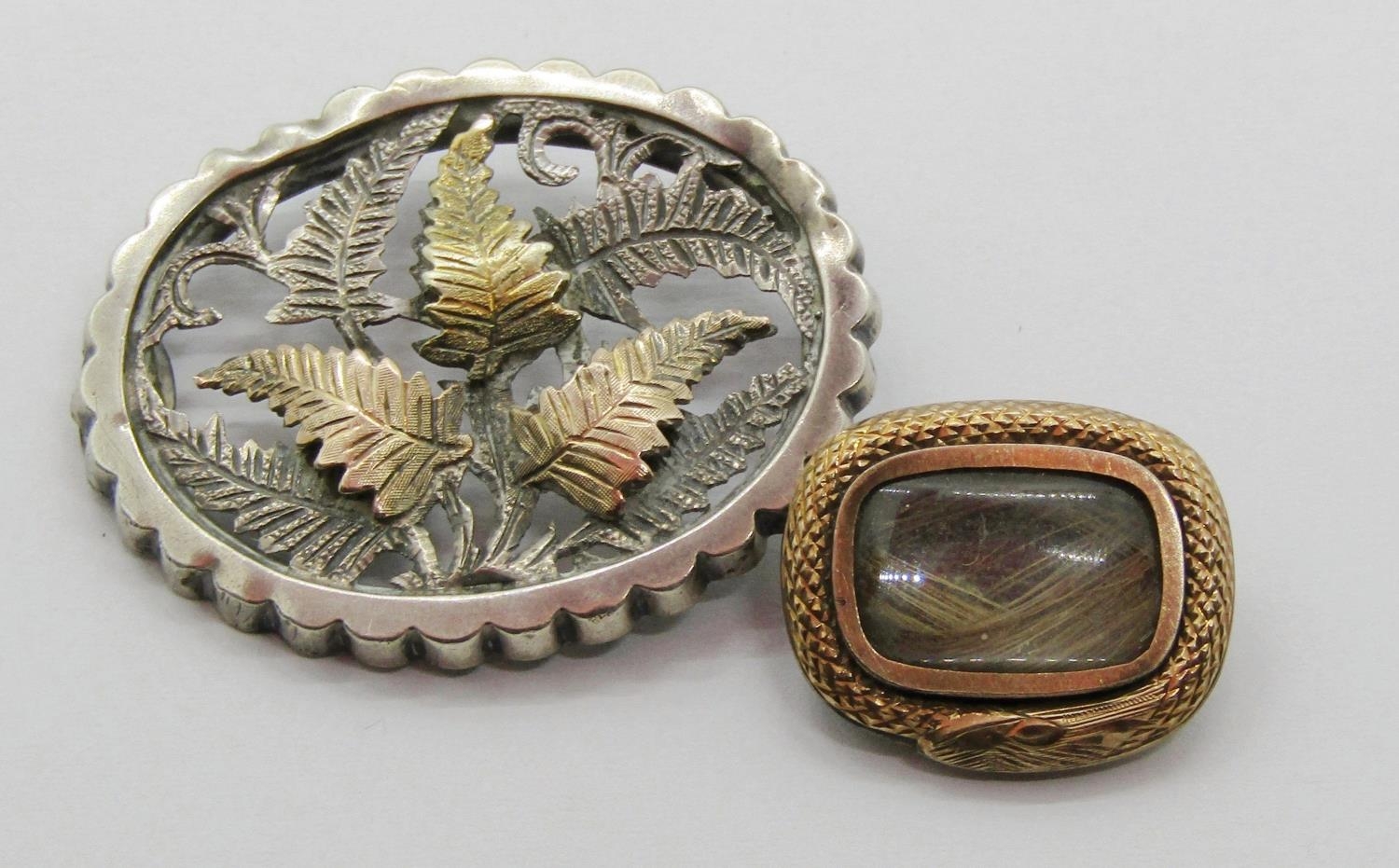 Georgian yellow metal mourning brooch containing a lock of hair, together with a further Aesthetic