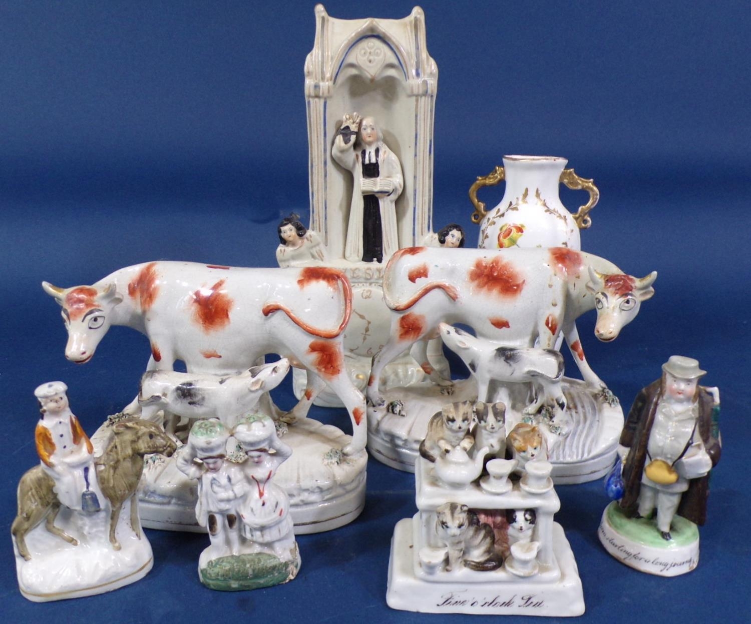 A 19th century flatback group showing Wesley Preaching, a pair of 19th century Staffordshire cow and