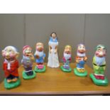 A set of hand painted garden ornaments of Snow White and the Seven Dwarfs