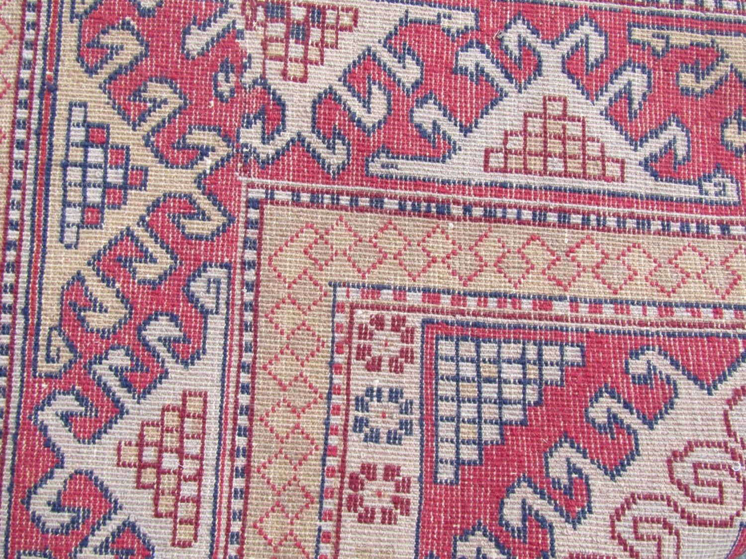 A Turkish Kazak Rug, with three hooked central medallions on a light brown field 189cm x 127cm, - Image 3 of 3