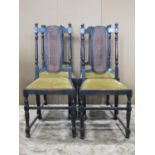 A set of four 1920s stained oak carolean style dining chairs with drop in upholstered seats raised