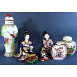 A miscellaneous collection of oriental porcelain including various plate, a pair of seated female