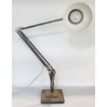 A Herbert Terry Anglepoise lamp set on a black two tier square cut base.