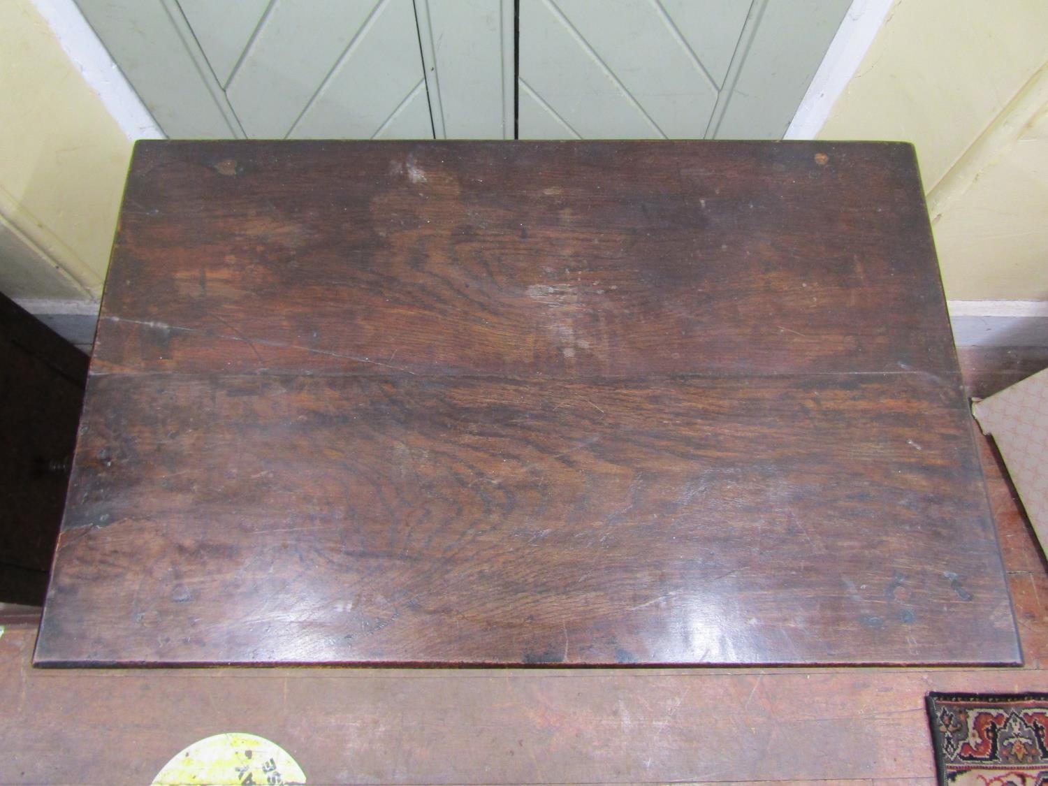 An 18th century oak side table the plank top raised on four turned supports and enclosing a frieze - Image 2 of 3