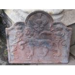 A heavy cast iron fire back of rectangular stepped arched form with lion, thistle and fleur-de-lys