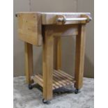 A beechwood kitchen butchers block trolley of square cut form with frieze drawer with oval label