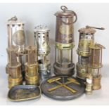 Seven miners lamps of various sizes including example by Thomas and Williams (used, stamped no 7)