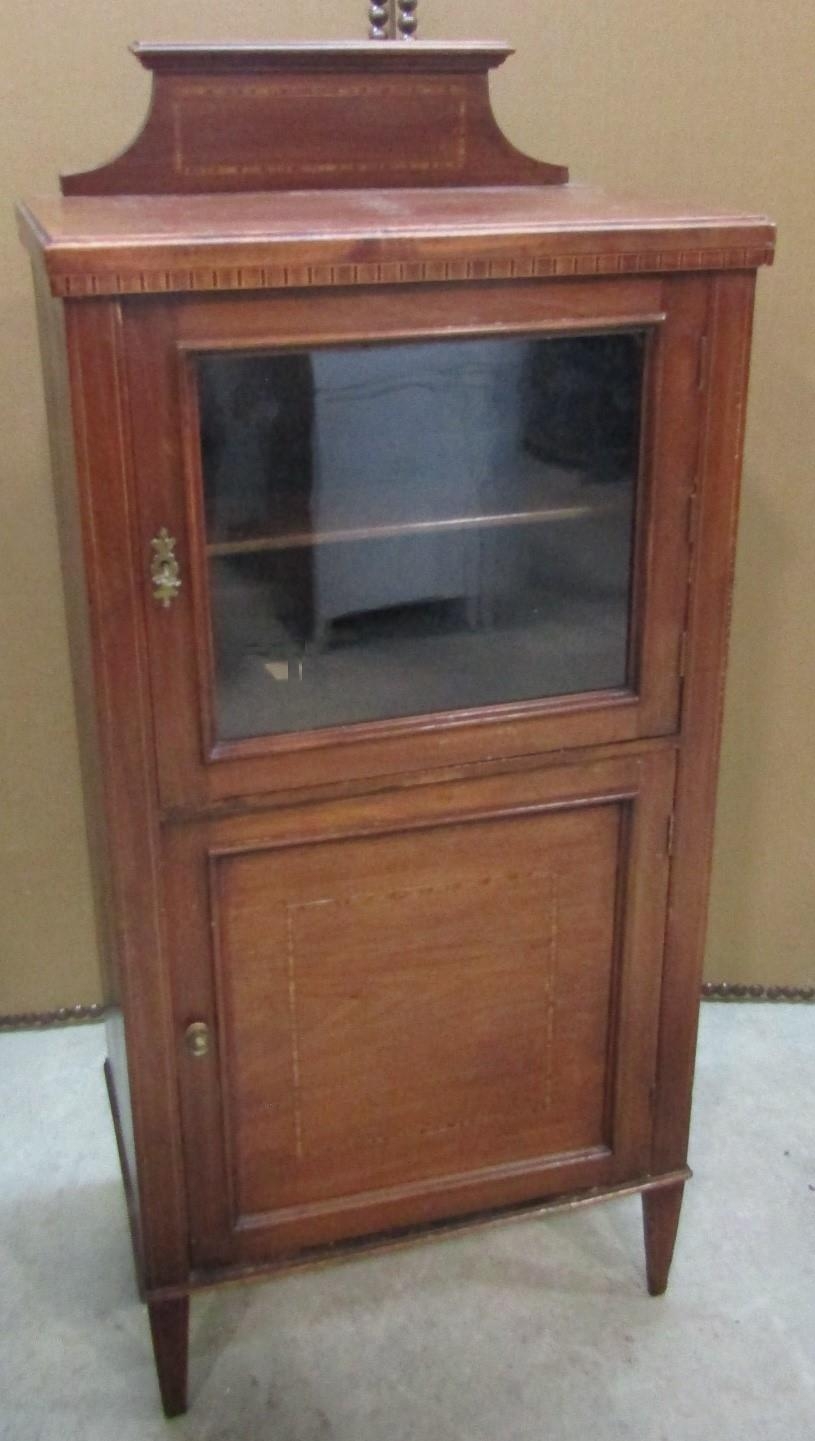 An inlaid Edwardian mahogany side/music cabinet enclosed by two panelled doors, the upper glazed,