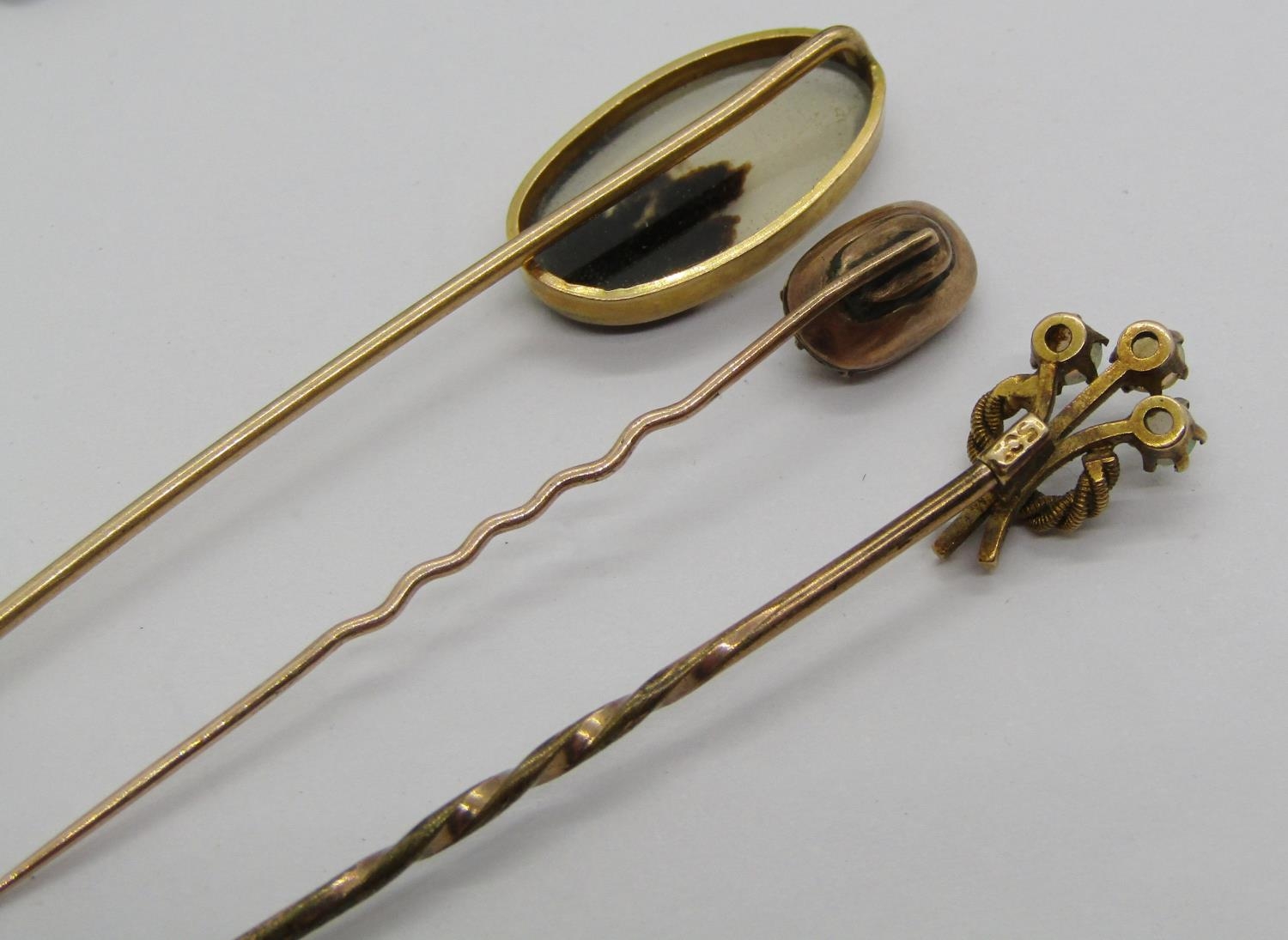 Three antique yellow metal stick pins to include an example with 15ct head set with three opals, 3. - Image 3 of 4