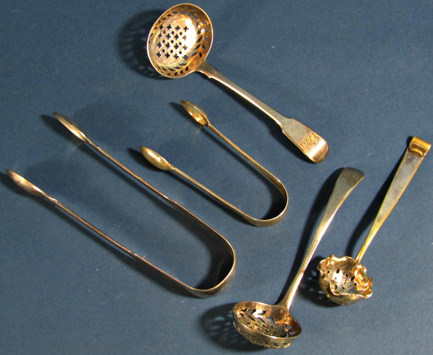 Three silver casting spoons (two Georgian) and two pairs of sugar tongs, 5 oz