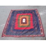 An old Middle Eastern kilim eating mat with a solitary stylised lamb to the centre of radiating