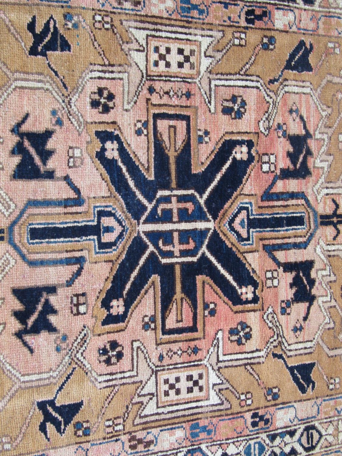 A North West Persian Heriz Runner with a central row of geometric symbols on a pale brown ground, - Image 2 of 3