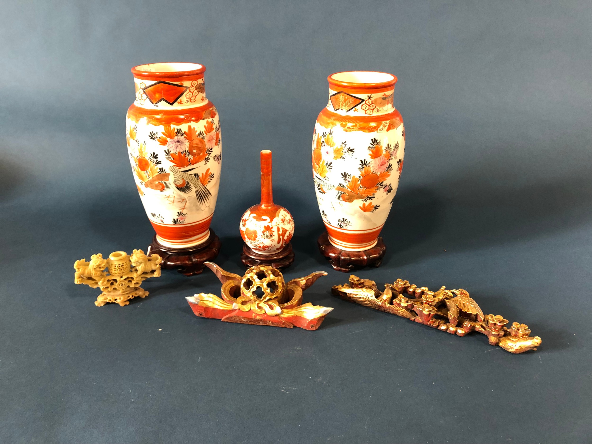 A pair of Imari baluster vases, 24cm high, another with slender neck, all on stands, a soapstone