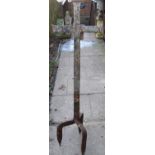 An old weathered wrought iron ecclesiastical cross raised on tripod stake supports, 130 cm high