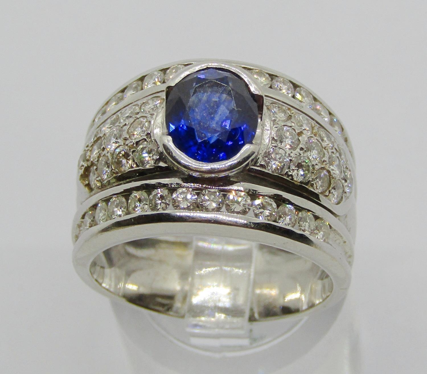 18ct white gold oval sapphire and pavé set diamond bombe style ring, size P, 13.3g