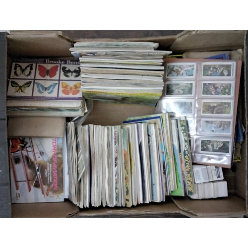 A box containing a large collection of albums of Brooke Bond and PG Tips cards, Wills a