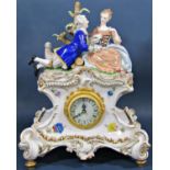 A contemporary porcelain mantle clock in the romantic style, surmounted by male and female