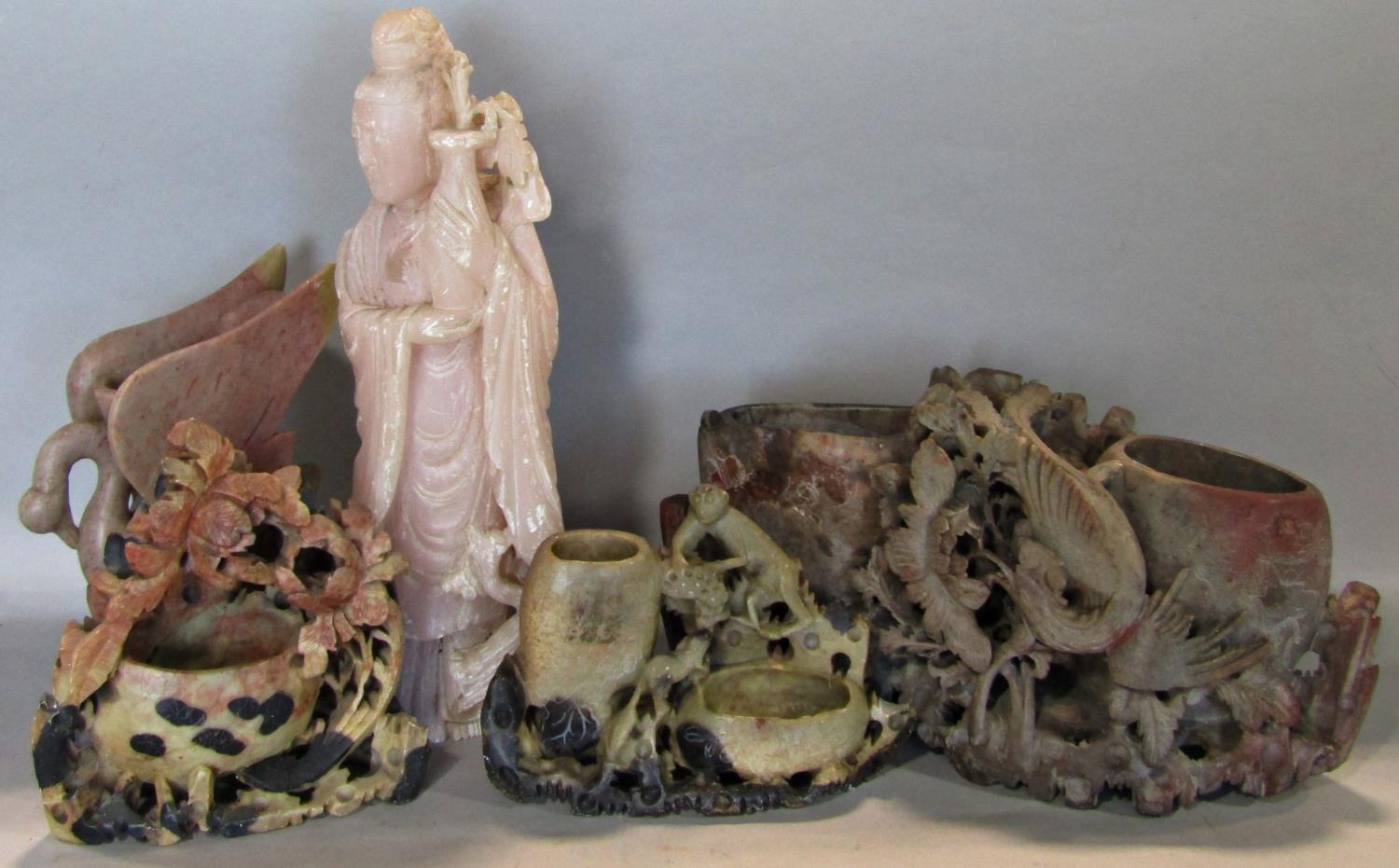 A small collection of soapstone carvings and brush pots surmounted monkeys and other animals,