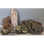 A small collection of soapstone carvings and brush pots surmounted monkeys and other animals,